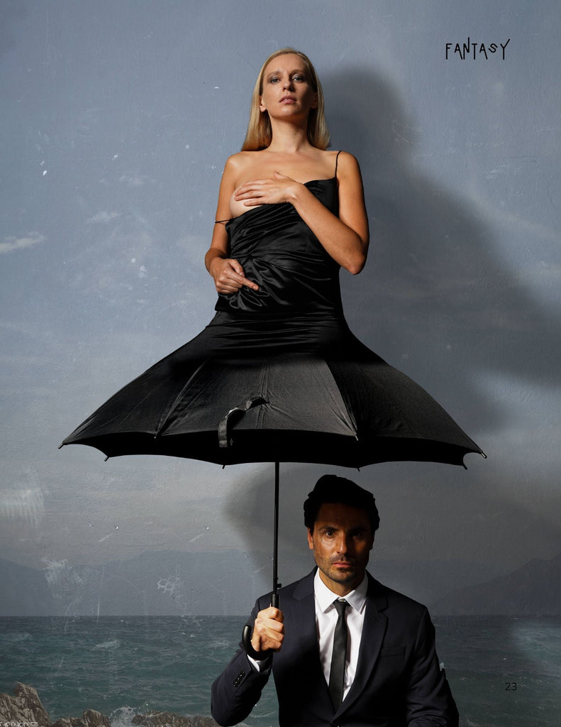 image by photographer graphyphoto in his dark and moody style. It is of a man with an umbrella with a lady coming out of it