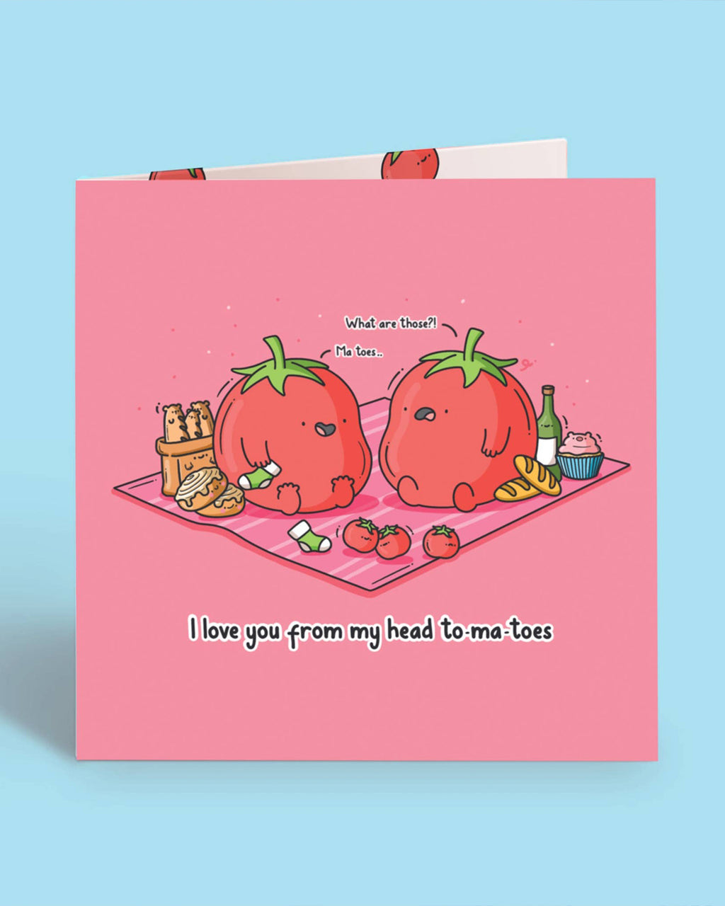 Front of a cute pink square greeting card featuring tomato characters sharing a pun: “I love you from my head to-ma-toes.” A funny and heartwarming Toastedink creation available at Rebel Romance, a UK brand that embraces quirky charm.