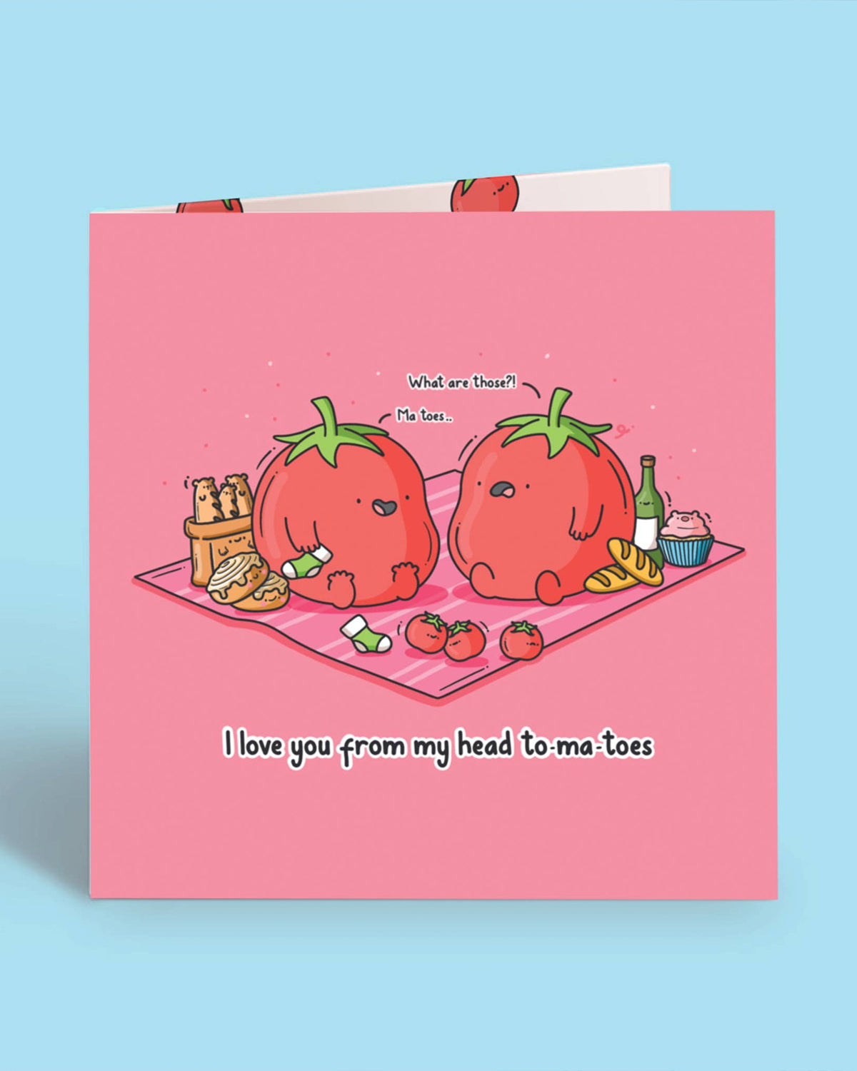 Front of a cute pink square greeting card featuring tomato characters sharing a pun: “I love you from my head to-ma-toes.” A funny and heartwarming Toastedink creation available at Rebel Romance, a UK brand that embraces quirky charm.