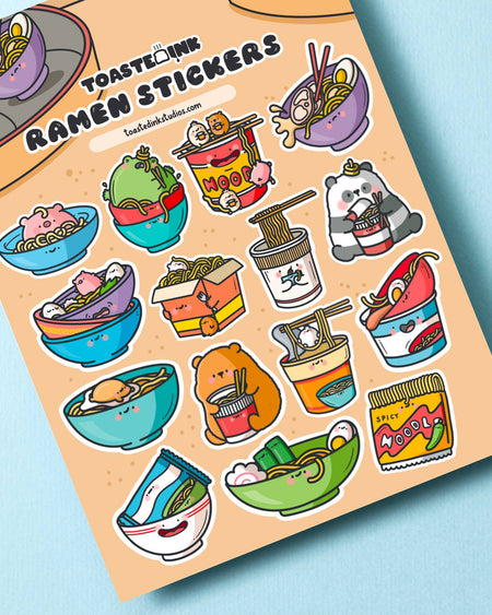 A cute ramen-themed sticker sheet by Toastedink, stocked by Rebel Romance. Features 16 adorable bowl and cup noodle illustrations with smiling faces on a peach coloured background. Perfect for journalling, planners and stationery fans.
