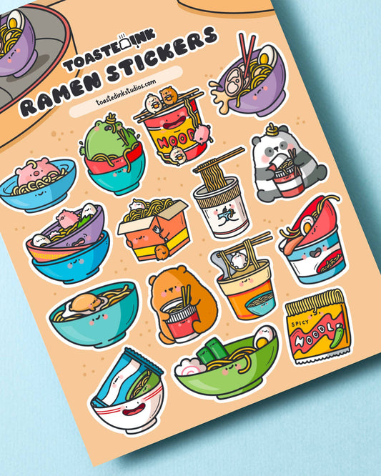 A cute ramen-themed sticker sheet by Toastedink, stocked by Rebel Romance. Features 16 adorable bowl and cup noodle illustrations with smiling faces on a peach coloured background. Perfect for journalling, planners and stationery fans.