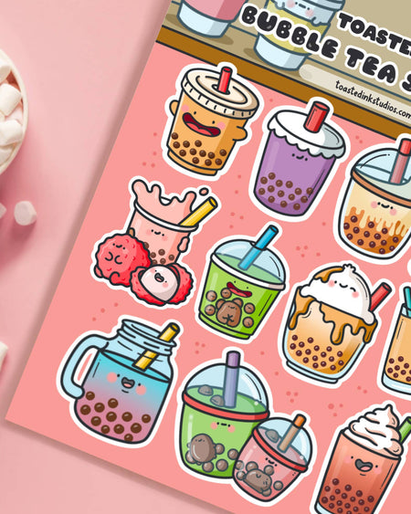 Close-up of a Toastedink Bubble Tea Sticker Sheet with cute characters including green matcha boba, lychee tea, caramel whipped tea and a mason jar boba. A pastel pink background complements the kawaii theme. Sold by Rebel Romance.