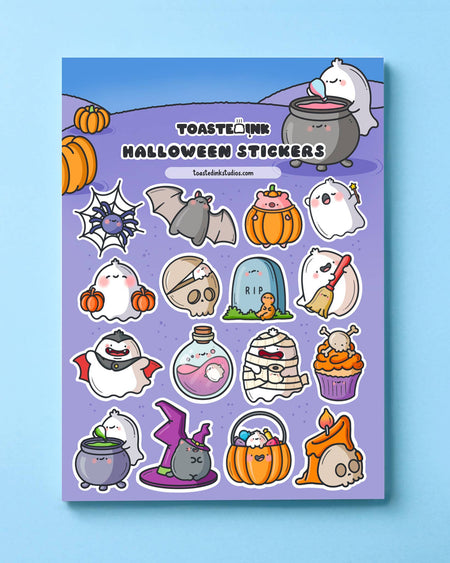 Full Halloween sticker sheet from Toastedink on blue background, with kawaii ghost characters dressed as vampires, witches, mummies, plus potion bottles, pumpkins and spooky treats – perfect for Halloween journaling.