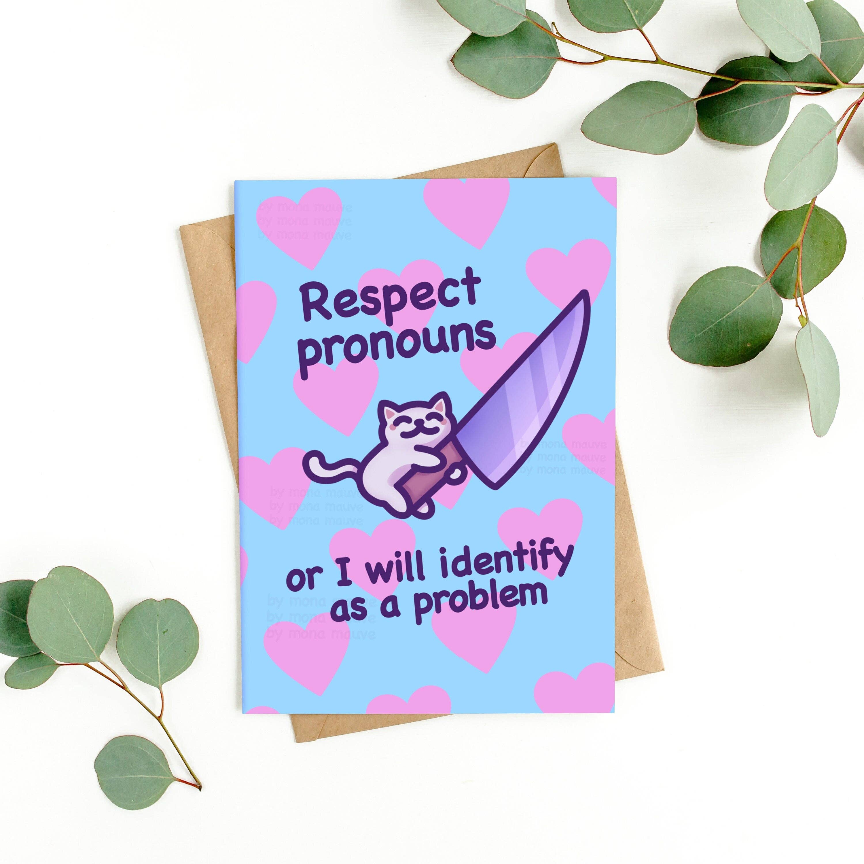 Humorous “Respect Pronouns” card by Mona Mauve for Rebel Romance placed on a white background with eucalyptus and kraft envelope. Features a white cartoon cat hugging a purple knife with pink hearts and bold supportive LGBTQIA+ text on a blue background.