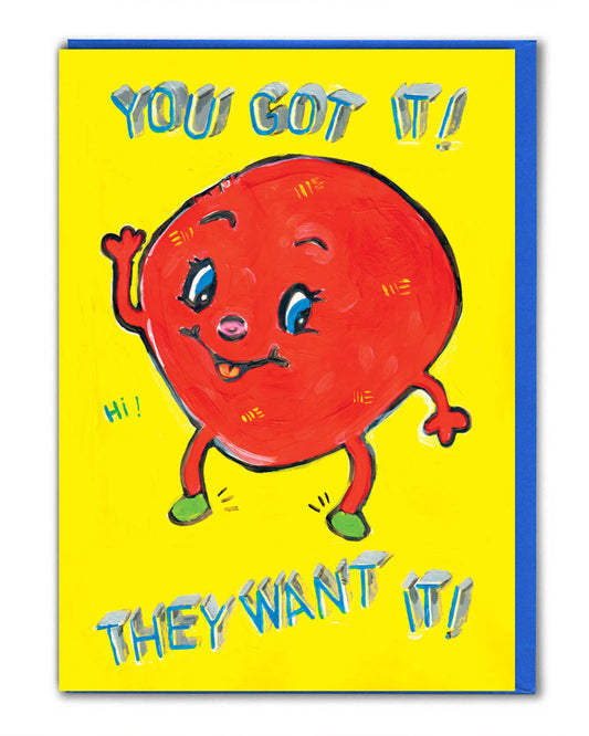 Rebel Romance greeting card illustrated by Magda Archer. The design features a kitschy red cartoon character with a cheeky face and waving hand on a bright yellow background. The bold text reads “YOU GOT IT! THEY WANT IT!” in playful blue 3D lettering. A quirky, retro-style card perfect for birthdays or celebrations. Printed sustainably in the UK, it comes with a bright blue envelope.
