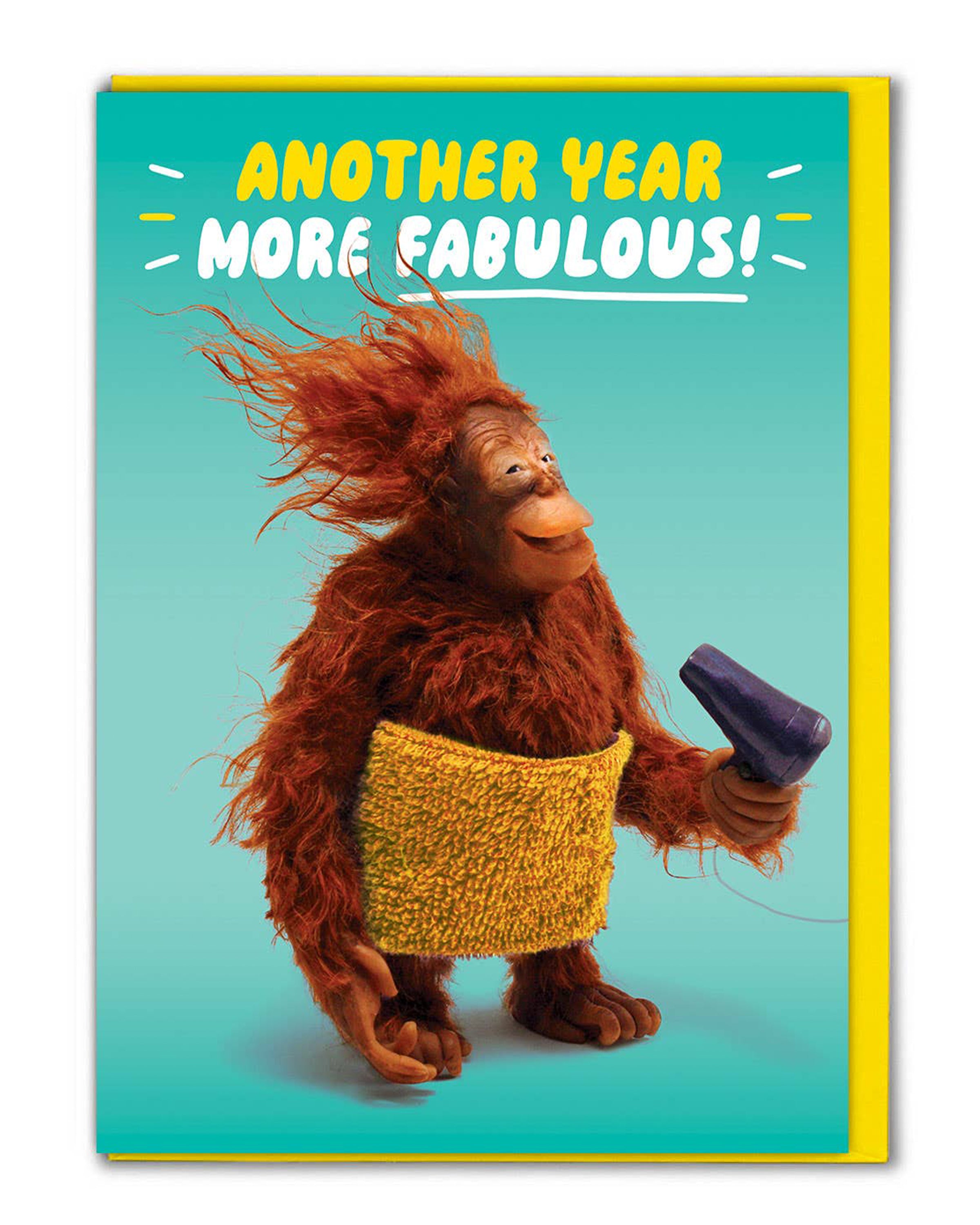 Rebel Romance Orangutan Another Year More Fabulous Funny Birthday Card. A quirky greeting card featuring a cheerful orangutan wrapped in a yellow towel, holding a hairdryer with windswept hair against a turquoise background. Caption reads “Another Year More Fabulous!” A playful, humorous birthday card printed in the UK, blank inside with envelope included. Perfect for millennials who love unique and alternative cards.