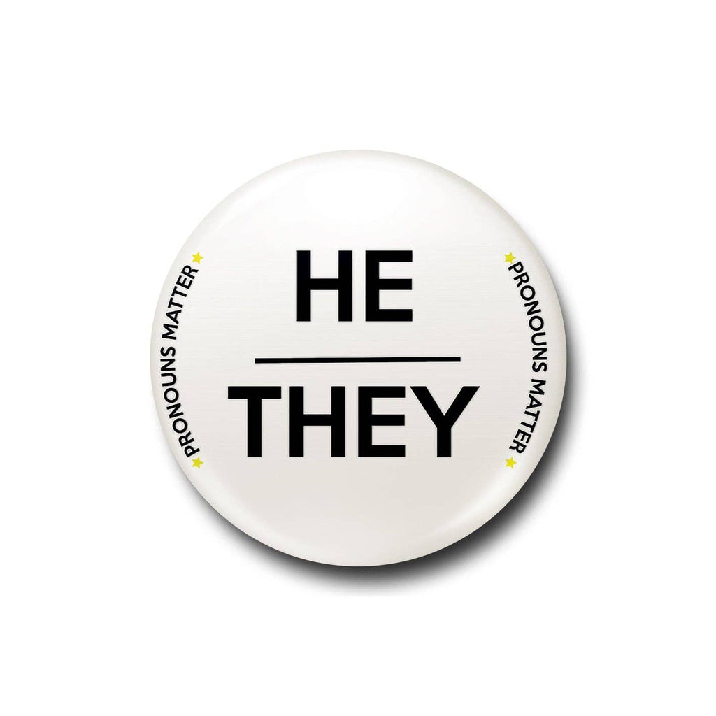 A white 25mm pin badge with bold black “He/They” text and “Pronouns Matter” written around the edge in a clean and modern font. A striking and meaningful accessory to celebrate inclusivity and individuality
