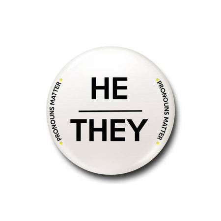 A white 25mm pin badge with bold black “He/They” text and “Pronouns Matter” written around the edge in a clean and modern font. A striking and meaningful accessory to celebrate inclusivity and individuality