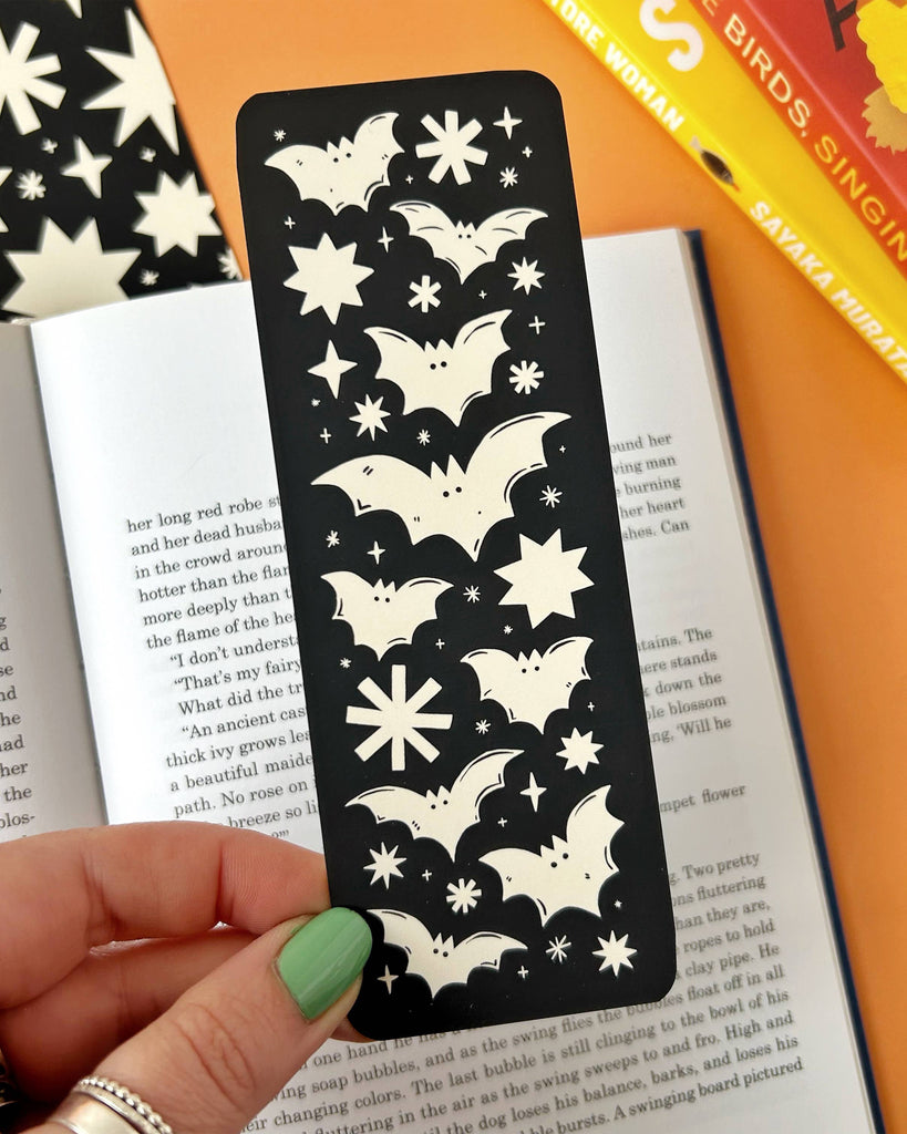 Discover the Bats Bookmark – a gothic Halloween-inspired accessory featuring a spooky bats and stars design by Stacey McEvoy Caunt. Luxurious velvet matte finish, 14.8 x 5.2 cm, and professionally printed in the UK. Perfect for book lovers and spooky season enthusiasts!