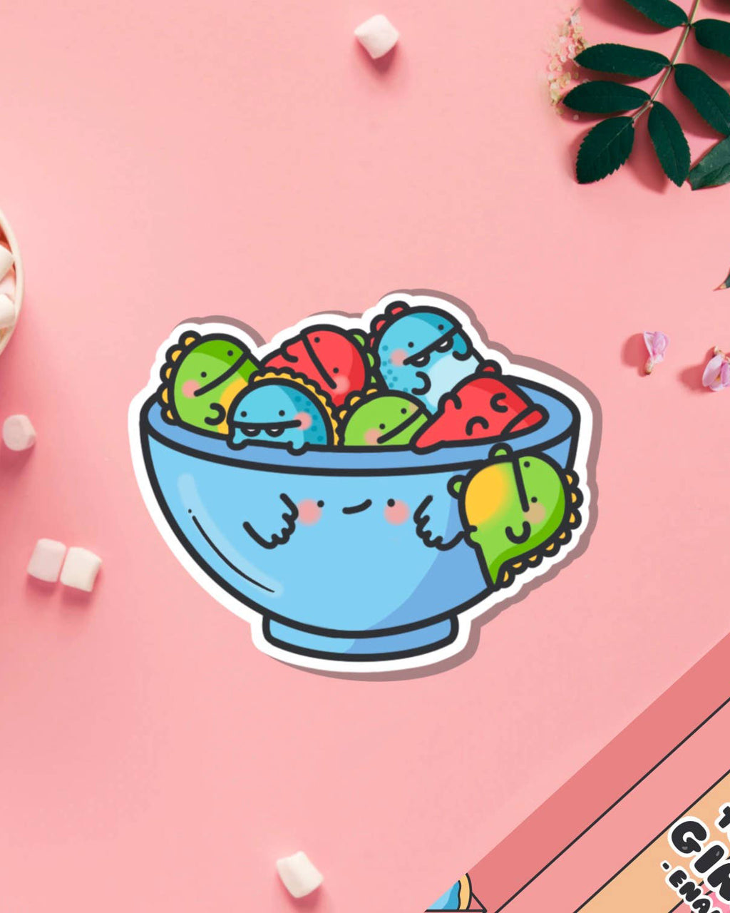 Cute dinosaur vinyl sticker by Toastedink, stocked by Rebel Romance. Features a smiling blue bowl filled with colourful cartoon dinosaurs. Ideal for decorating laptops, notebooks and water bottles. A quirky sticker gift for dinosaur lovers.