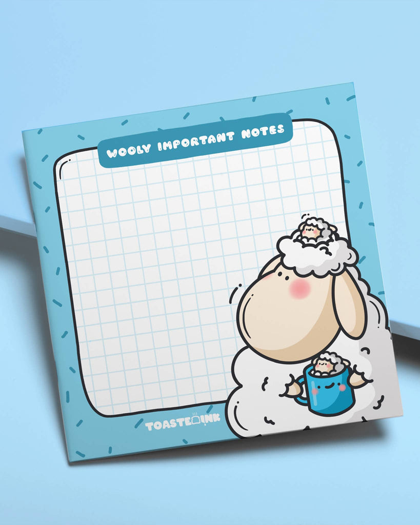 Fun and fluffy sheep-themed sticky note pad from Rebel Romance featuring Toastedink’s adorable sheep holding a blue mug. Grid design for tidy note-taking with a blue sprinkle border and pun heading “Wooly Important Notes”. Styled on pastel blue background.