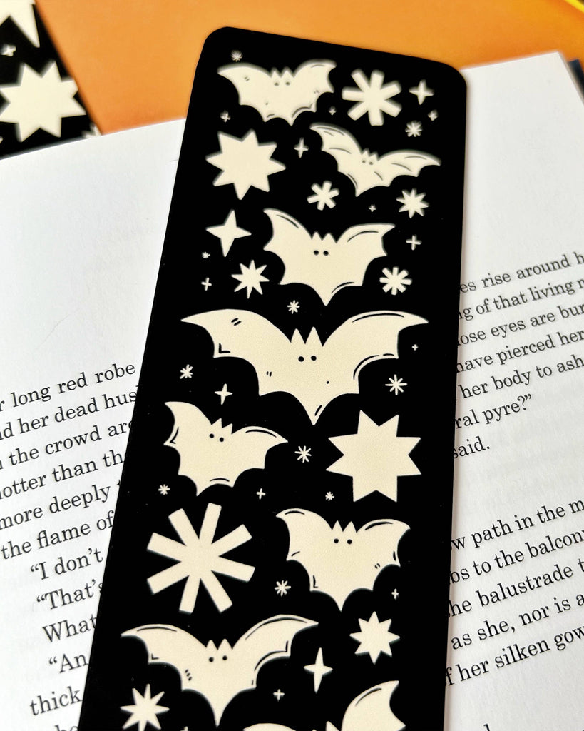 Discover the Bats Bookmark – a gothic Halloween-inspired accessory featuring a spooky bats and stars design by Stacey McEvoy Caunt. Luxurious velvet matte finish, 14.8 x 5.2 cm, and professionally printed in the UK. Perfect for book lovers and spooky season enthusiasts!