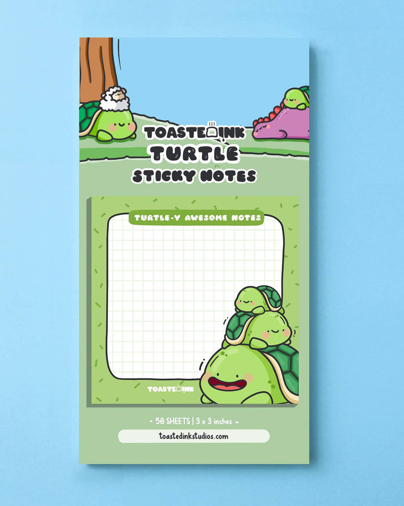 Packaged “Turtle-y Awesome Notes” sticky notes by Toastedink, featuring three smiling turtles on each sheet and playful cartoon artwork. Includes a branded backing card with forest and dinosaur characters. Stocked by Rebel Romance, a UK indie shop for unique and cute gifts.