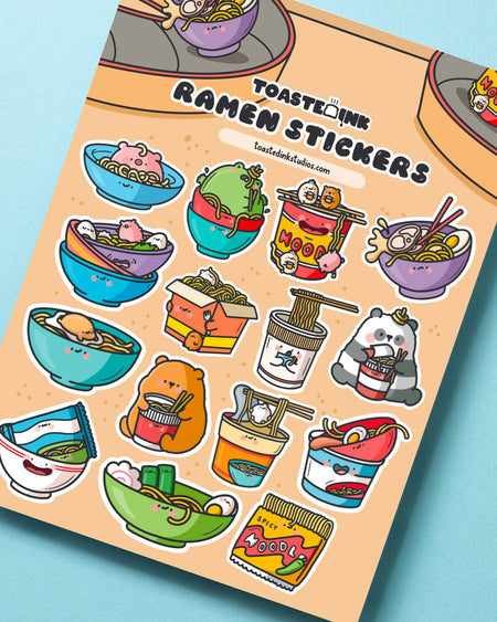 Whimsical ramen sticker sheet featuring smiling noodle bowls and instant cups with playful designs. Designed by Toastedink and available from Rebel Romance, a UK small biz celebrating quirky style.