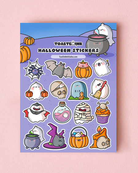 Flat lay of Halloween stickers by Toastedink on a pink background, with cute ghost, tombstone, skull, pumpkin, bat, and candy illustrations arranged in a fun, whimsical style for planners and scrapbooks.