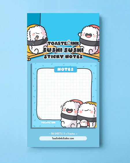 Cute Toastedink Sushi Sticky Notes designed with smiling sushi characters on a blue 3x3 inch notepad, displayed in its full packaging. Sold by Rebel Romance, a UK-based alternative lifestyle shop.