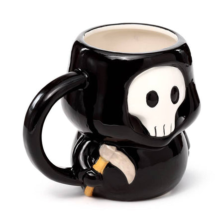 Three-quarter view of the Skull Boy Shaped Mug showing its handle and skull detail while holding a tiny scythe. A gothic ceramic cup from UK brand Rebel Romance, perfect for Halloween lovers.