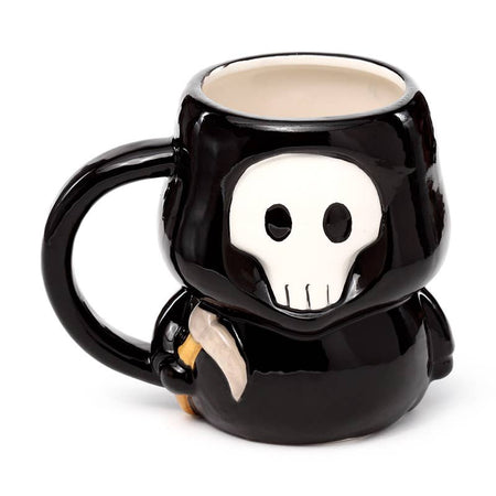 Front-facing view of the Skull Boy Ceramic Mug featuring a stylised white skull face with black eyes and robe. A spooky and adorable mug from Rebel Romance’s alternative homeware collection.