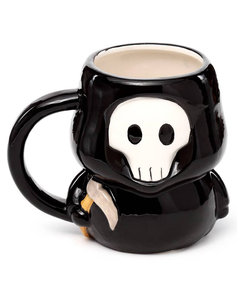 Front-facing view of the Skull Boy Ceramic Mug featuring a stylised white skull face with black eyes and robe. A spooky and adorable mug from Rebel Romance’s alternative homeware collection.