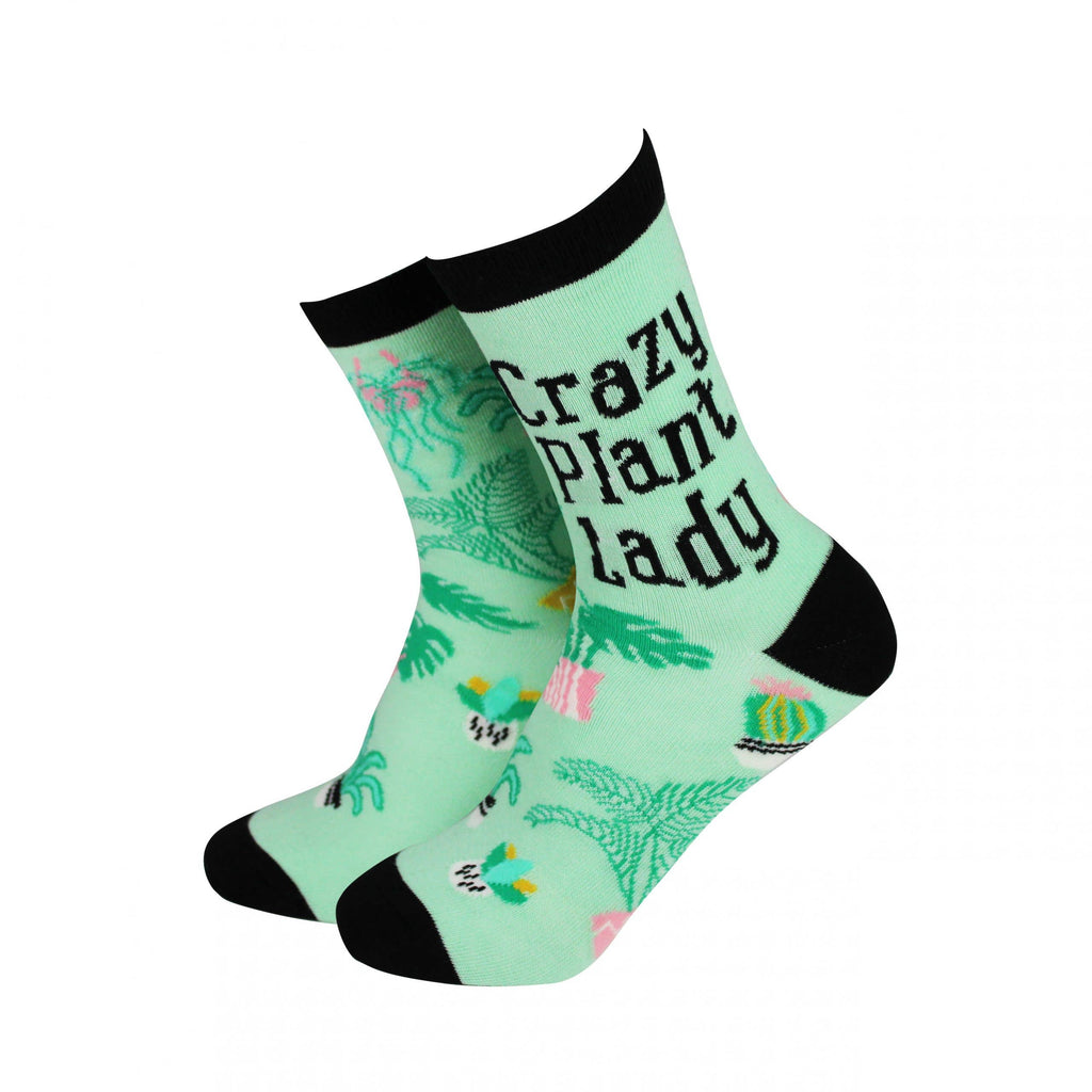 Mint-green bamboo socks by Smiling Faces, with playful 'Crazy Plant Lady' text and vibrant plant illustrations. Contrasting black toes and cuffs, eco-friendly, ideal for plant lovers, available at Rebel Romance.
