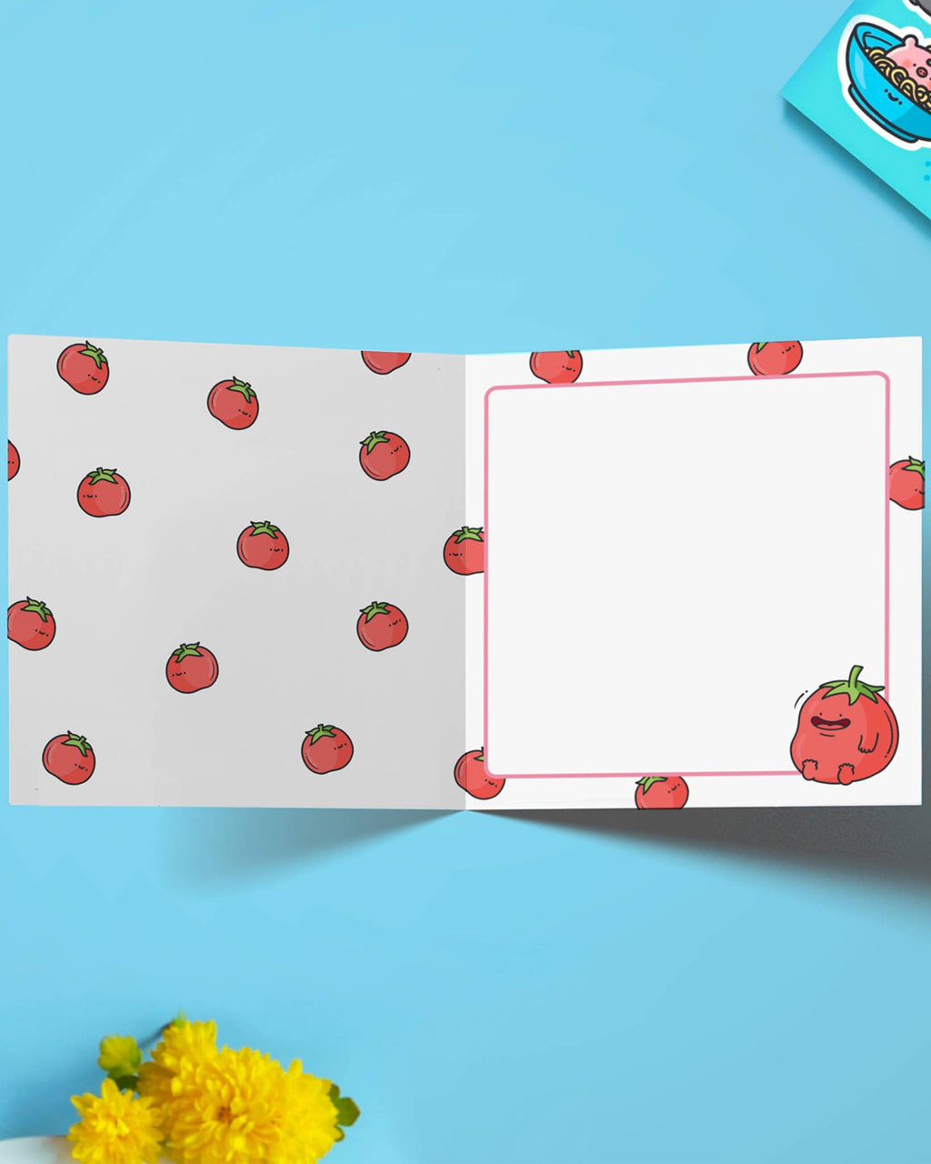 Inside view of the greeting card with a patterned tomato design across both pages. The right side has space to write, bordered by mini tomatoes, with one smiling tomato in the corner. A cute and quirky card stocked by Rebel Romance.