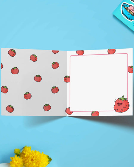 Inside view of the greeting card with a patterned tomato design across both pages. The right side has space to write, bordered by mini tomatoes, with one smiling tomato in the corner. A cute and quirky card stocked by Rebel Romance.