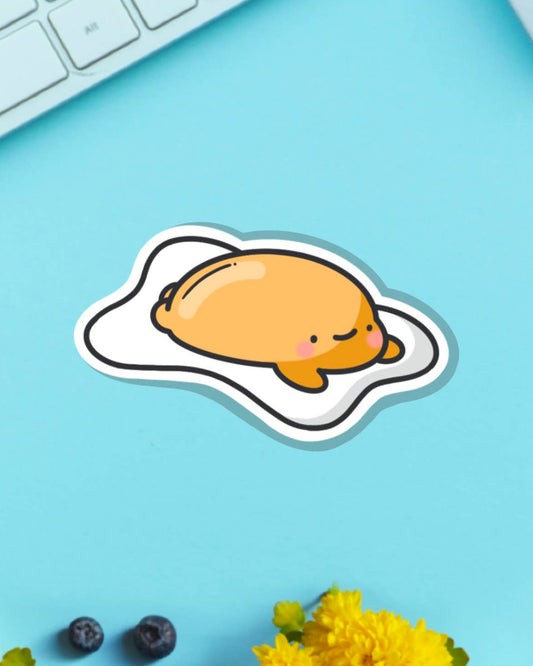 Toastedink's cute fried egg sticker featuring a relaxed yolk character on a blue backdrop. Perfect for decorating laptops, water bottles and journals. Available from Rebel Romance, a UK lifestyle brand for fun and foodie sticker fans.
