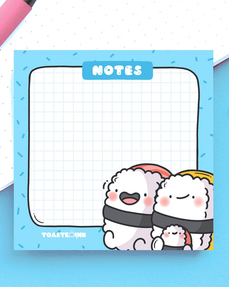 Kawaii-style sticky notes with adorable sushi characters, perfect for jotting reminders. Grid design with blue background. Sold by Rebel Romance, UK stockist of alternative cute gifts.