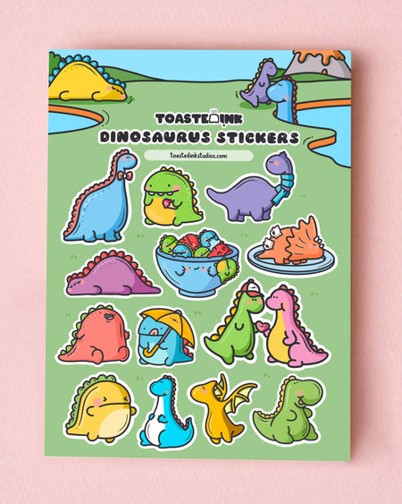 Adorable dinosaur sticker sheet by Toastedink with colourful dinos on a green backdrop. Includes playful characters like a purple dino in a scarf and an orange sushi dino on a plate. A cute and quirky design sold by Rebel Romance in the UK.