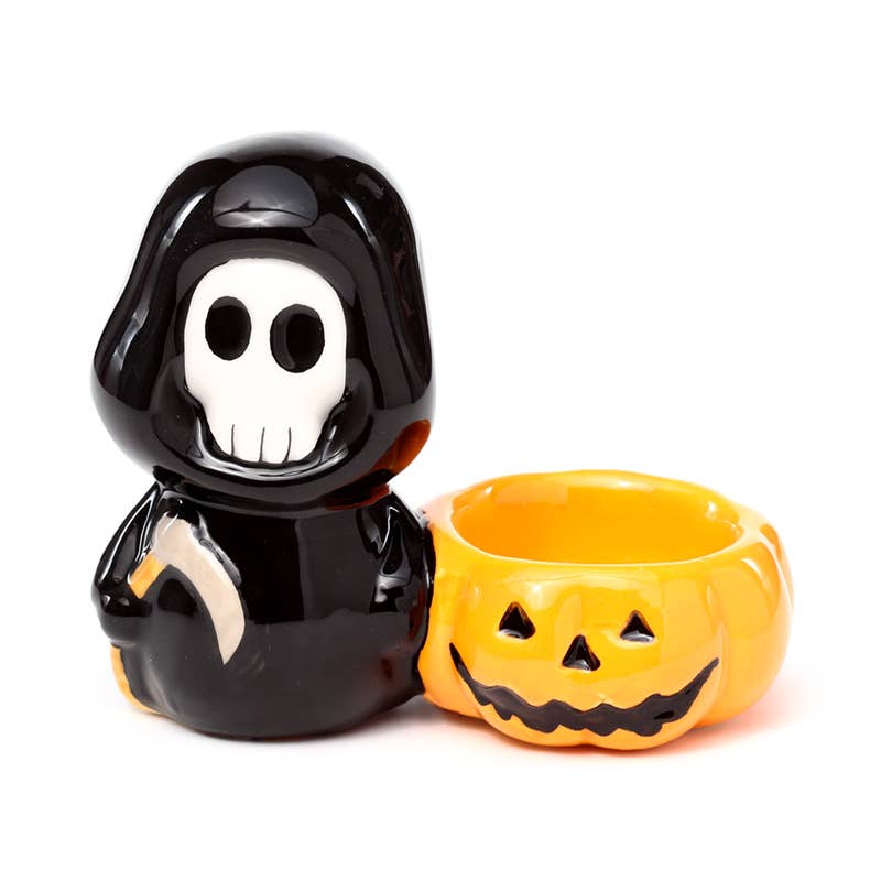Front view of the Ceramic Skull Boy Candle Holder showing the grinning skull face and pumpkin tea light bowl. A fun, gothic-inspired ceramic piece from Rebel Romance, made for spooky season fans and alternative style lovers.