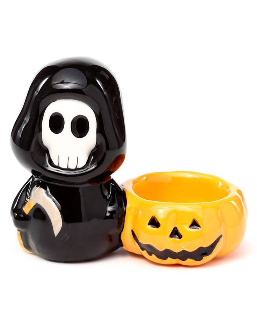 Front view of the Ceramic Skull Boy Candle Holder showing the grinning skull face and pumpkin tea light bowl. A fun, gothic-inspired ceramic piece from Rebel Romance, made for spooky season fans and alternative style lovers.