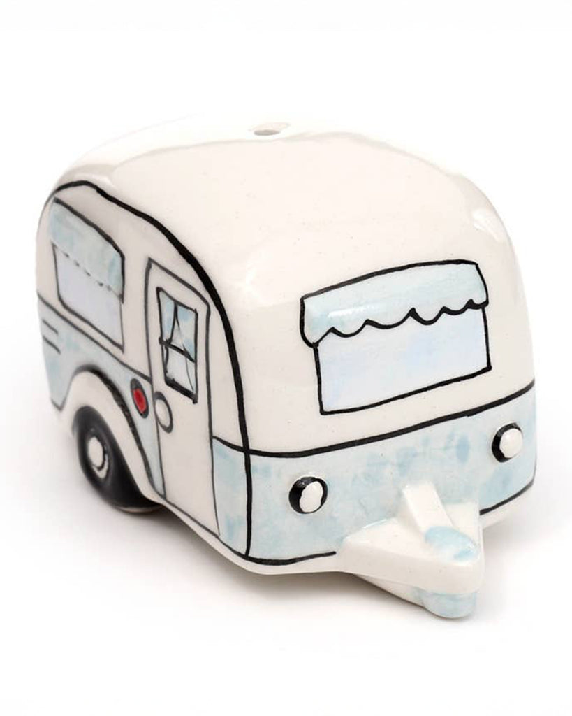A ceramic salt or pepper shaker styled like a retro caravan in cream and pastel blue, complete with hand-drawn windows and tiny wheels. A charming, quirky gift from Rebel Romance, ideal for millennial campers and collectors.
