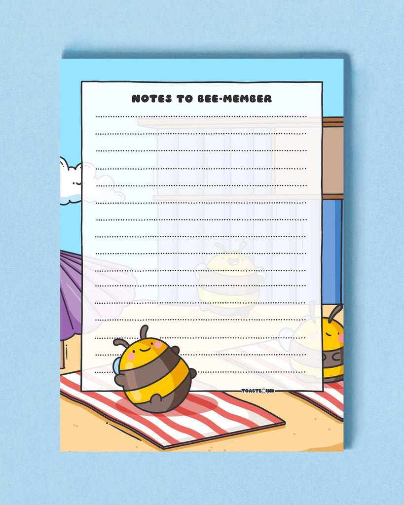 Whimsical bee notepad by Toastedink, available at Rebel Romance. A6 pad with lined paper and a cheerful bee lounging in the sun. Set on a soft blue backdrop.