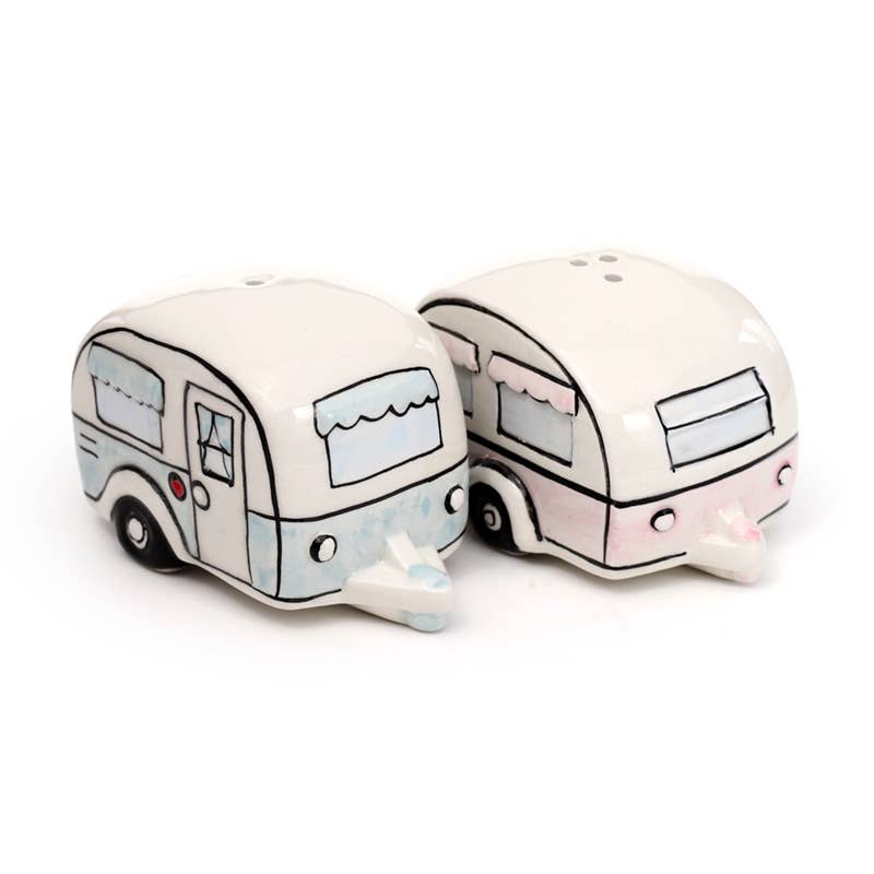 A close-up of the full ceramic salt and pepper set from Rebel Romance. Includes two shakers: a pastel pink caravan and a pastel blue one, each with unique illustrated detailing. A playful, retro-inspired kitchen or campervan accessory.