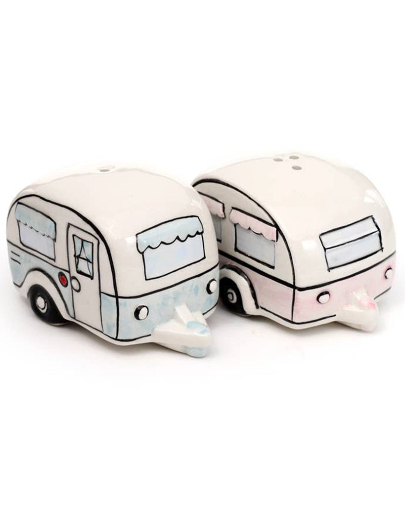 A close-up of the full ceramic salt and pepper set from Rebel Romance. Includes two shakers: a pastel pink caravan and a pastel blue one, each with unique illustrated detailing. A playful, retro-inspired kitchen or campervan accessory.