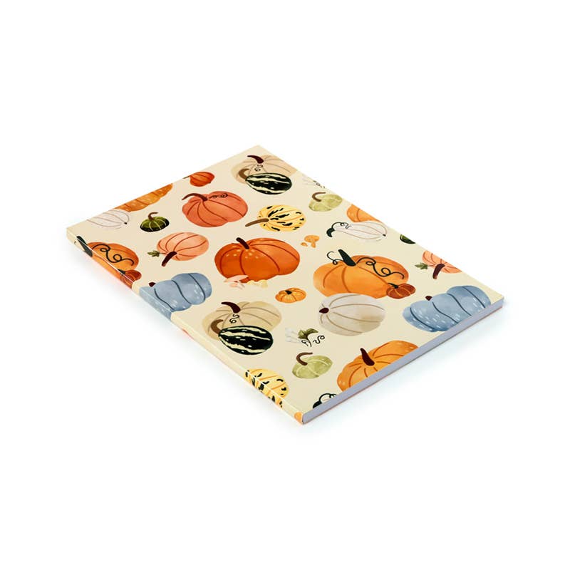 Flat-lay of the Autumn Harvest Notepad by Rebel Romance. The recycled paper notepad features a soft cream background with a playful all-over print of colourful pumpkins and gourds in orange, green, blue and yellow tones—perfect for autumn journalling or list-making.