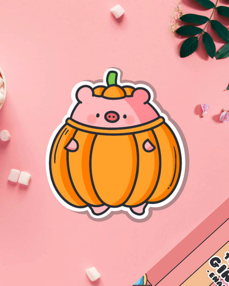 Vinyl sticker of a cute pink pig dressed in a bright orange pumpkin costume with a green stalk hat, designed by Toastedink and stocked by Rebel Romance. Styled on a pastel pink background with marshmallows and petals. A perfect kawaii sticker for laptops, water bottles, or notebooks. Great for autumn vibes or Halloween aesthetic.
