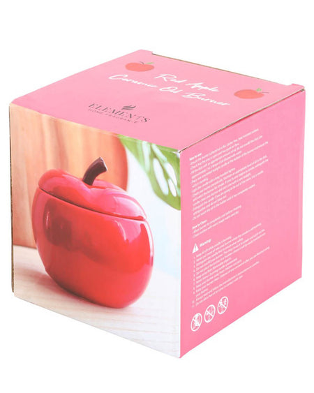 The Red Apple Ceramic Oil Burner packaged in a pink box, featuring an image of the burner and product details.