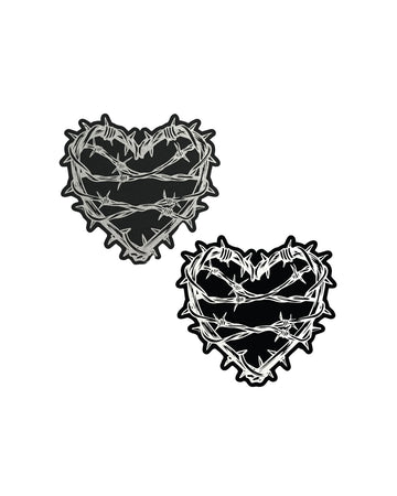The Barbed Wire Heart Pasties Reflective Nipple Covers by Pastease®. Two black hearts with silver reflective barbed wire patterned shaped nipple covers shown on a white background. Perfect for festivals, pride, burlesque, raves, only fans content or parties.