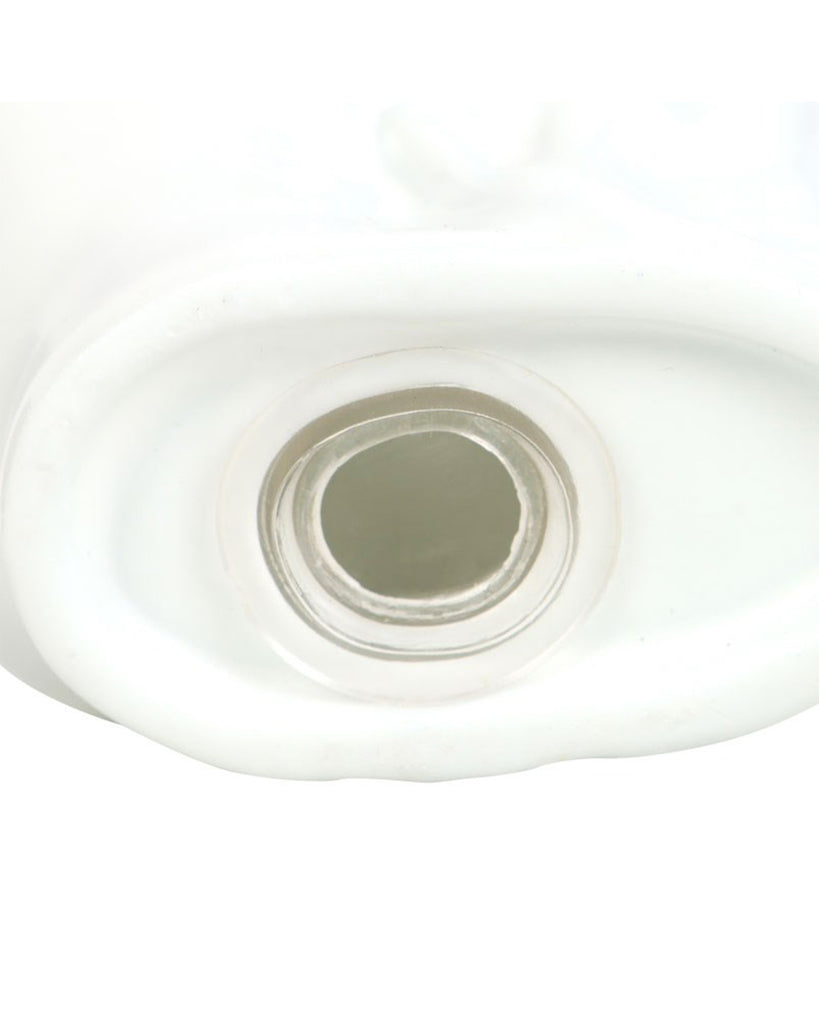 Close-up of the base opening of a ceramic skull salt and pepper shaker with a plastic stopper.