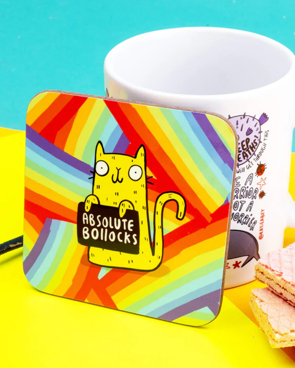 Yellow coaster featuring a cartoon cat holding a black sign that says 