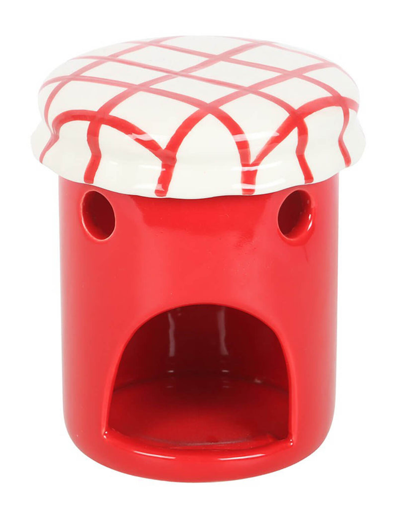  Front view of the oil burner with the lid removed, showing the open chamber for a tealight candle and two small round side vents.