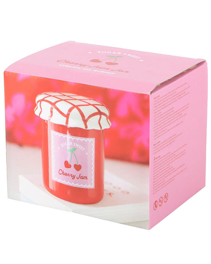 The oil burner in its packaging, which is a pink box featuring an image of the burner and the label ‘Sugar Sweet Cherry Jam.’
