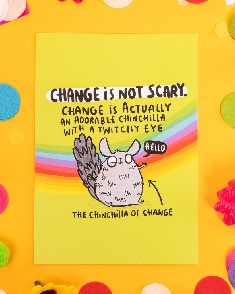 A brightly coloured A6 motivational postcard featuring a hand-drawn grey chinchilla with a twitchy eye, waving next to the text: "Change is not scary. Change is actually an adorable chinchilla with a twitchy eye." Designed by Katie Abey with rainbow colours and playful illustration style.