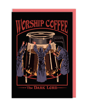 Front view of a dark-themed greetings card featuring a retro-style design of robed figures worshipping a coffee pot, surrounded by text reading “Worship Coffee, The Dark Lord,” photographed with a matching red envelope.