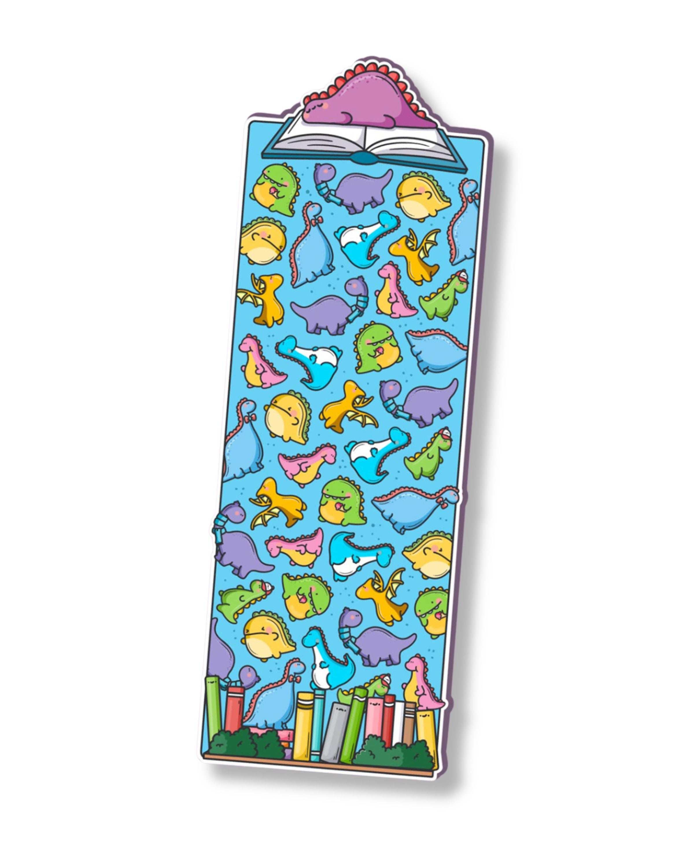 Cute dinosaur bookmark by Toastedink, sold by Rebel Romance, featuring colourful cartoon dinosaurs scattered across a blue background, with a pink dinosaur