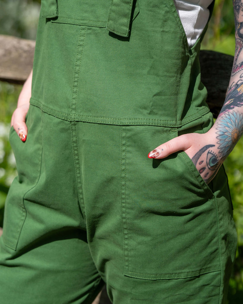 Close-up of the Forest Green Stretch Twill Dungarees showing the front bib and deep side pockets, highlighting the durable twill fabric.