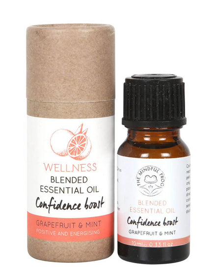 A 10ml amber glass bottle of Grapefruit & Mint Blended Essential Oil labeled “Confidence Boost,” alongside a recyclable cardboard tube with a minimalist design and grapefruit illustration. The label highlights “Positive and Energising” benefits from The Mindful Frog brand.