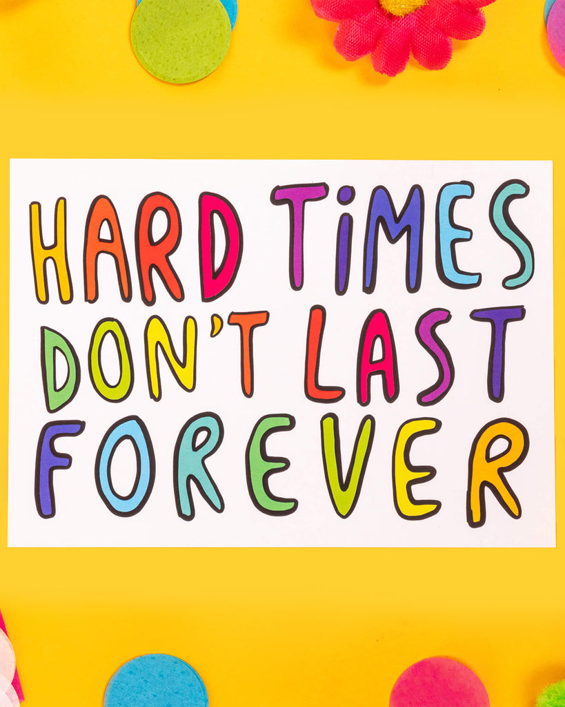 A bright and colourful A6 postcard featuring the hand-lettered text “Hard Times Don’t Last Forever” in rainbow colours on a white background. Designed by Katie Abey, this motivational print offers a hopeful and uplifting message to inspire resilience.
