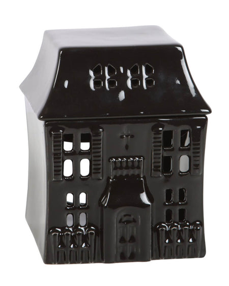 The full view of the haunted house oil burner with gothic detailing, tiny window cutouts, and a pointed roof, against a neutral background.